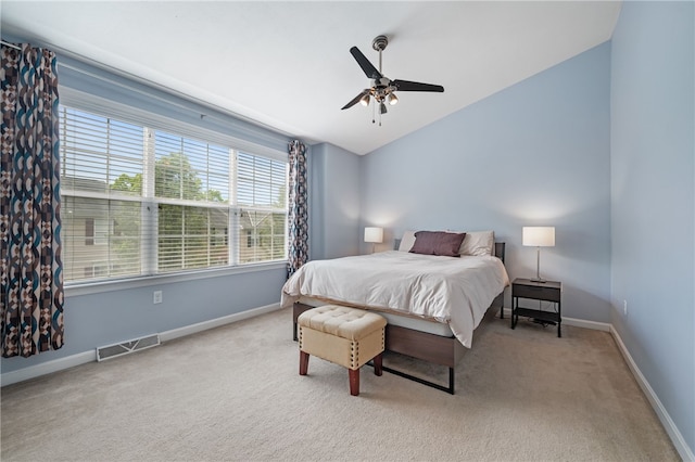 bedroom with carpet floors, vaulted ceiling, baseboards, and ceiling fan
