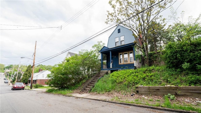 321 Kennedy Ave, Perry Hilltop, PA 15214 - view of front of house featuring a gambrel roof, stairway, and a porch