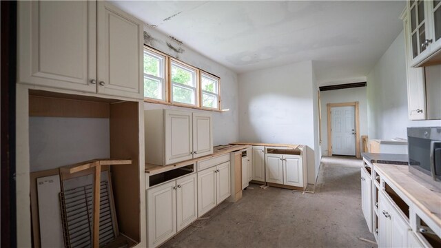 321 Kennedy Ave, Perry Hilltop, PA 15214 - kitchen with stainless steel microwave, light countertops, and glass insert cabinets