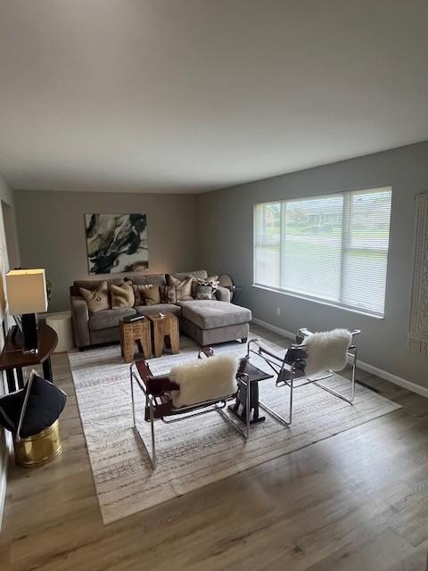 living area featuring wood finished floors and baseboards