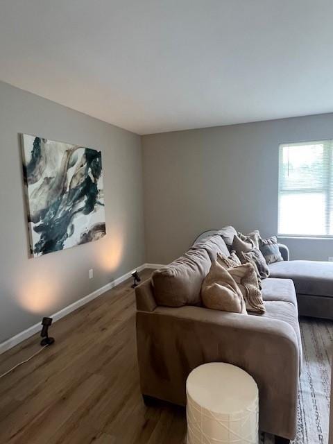 living area with wood finished floors and baseboards