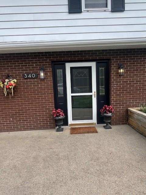 entrance to property with brick siding