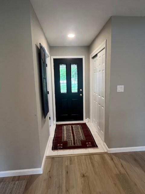entryway with wood finished floors and baseboards