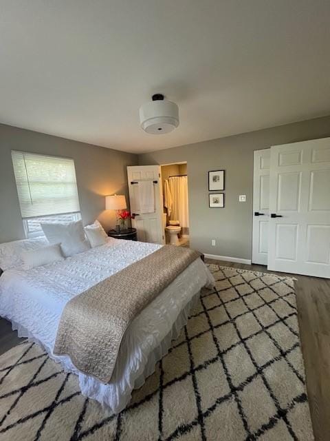 bedroom with wood finished floors and baseboards