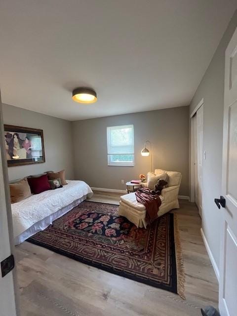 bedroom featuring wood finished floors and baseboards