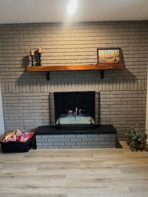 detailed view of wood finished floors and a fireplace