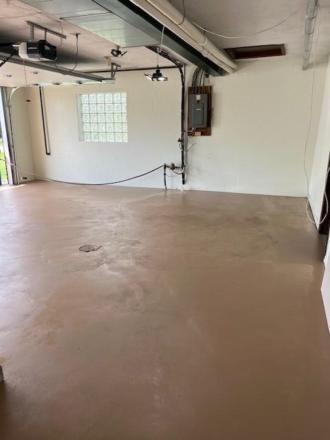 garage featuring a garage door opener and electric panel