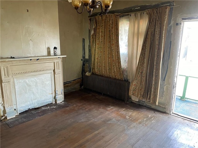 230 E 15th Ave, Homestead, PA 15120 - unfurnished living room featuring a chandelier, hardwood / wood-style floors, and radiator heating unit