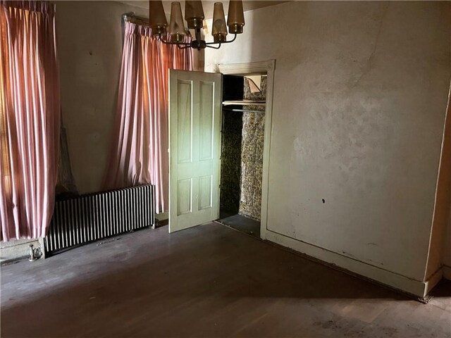 230 E 15th Ave, Homestead, PA 15120 - unfurnished dining area with radiator heating unit and a chandelier