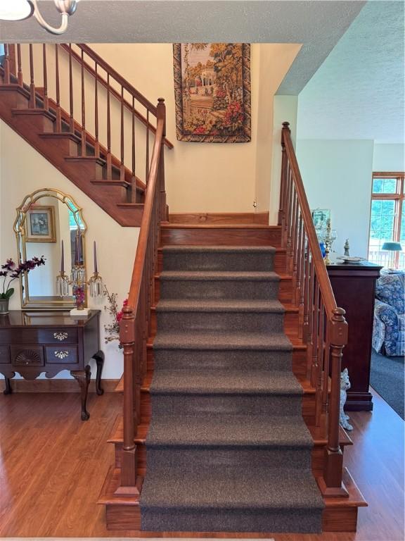 16 Finnin Rd, Allegheny Twp Wml, PA 15068 - stairs with wood finished floors, a textured ceiling, and baseboards
