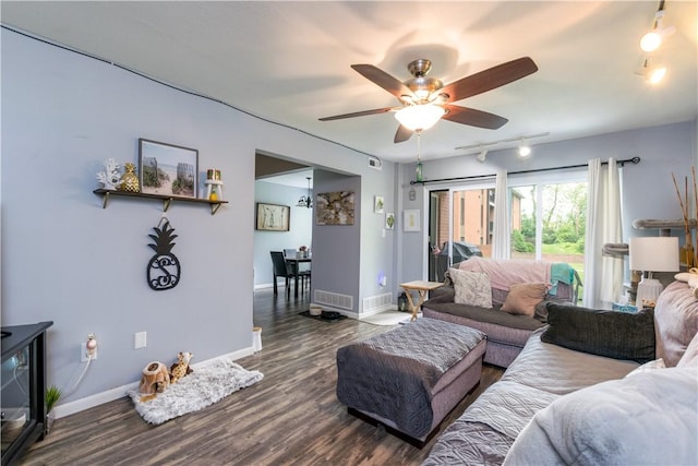 living room with ceiling fan, dark wood-style flooring, baseboards, and rail lighting