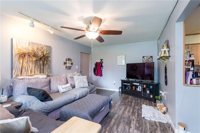 living room featuring wood finished floors, a ceiling fan, rail lighting, and baseboards