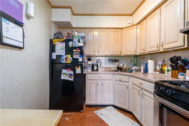 kitchen with freestanding refrigerator, gas range, ornamental molding, a sink, and light countertops