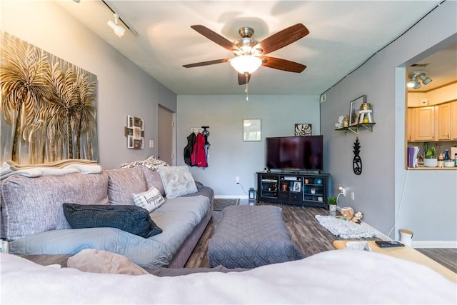 living area featuring dark wood-style flooring, ceiling fan, and baseboards