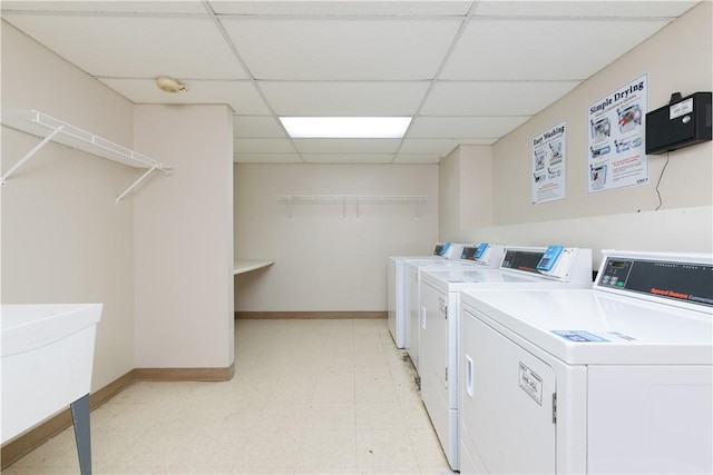 community laundry room with independent washer and dryer, baseboards, and light flooring