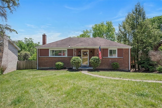 view of front of home with a chimney and brick siding