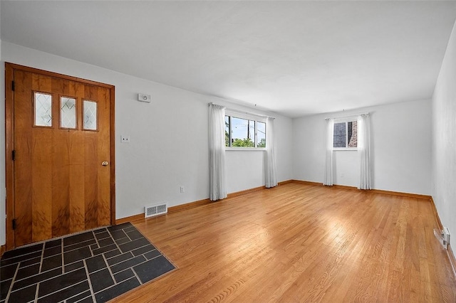 entrance foyer with light wood-style flooring and baseboards