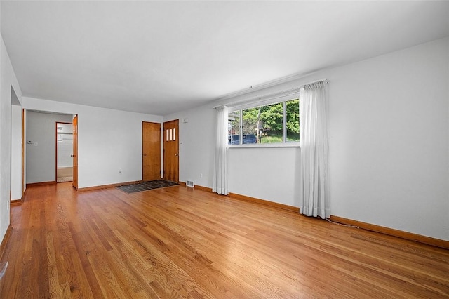 unfurnished room featuring light wood-style flooring and baseboards