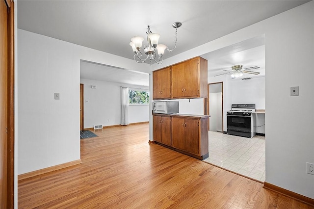 kitchen featuring range, a chandelier, brown cabinets, light wood-style flooring, and a ceiling fan