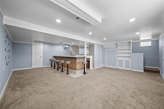 below grade area featuring carpet, recessed lighting, baseboards, and a dry bar
