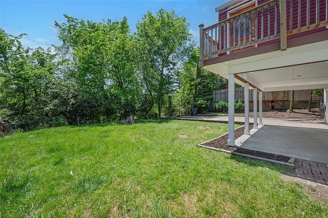 view of green lawn featuring a patio and a carport