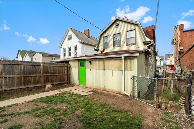 816 E 11th Ave, Munhall, PA 15120 - back of house featuring a gambrel roof, fence, and a gate