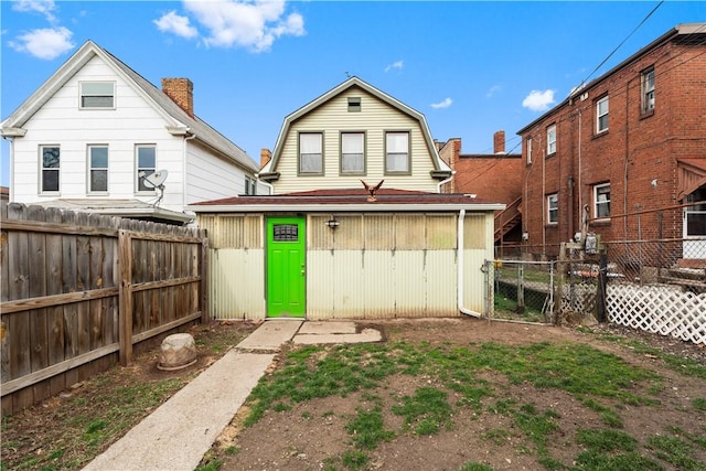 816 E 11th Ave, Munhall, PA 15120 - rear view of house featuring a fenced backyard and a gambrel roof