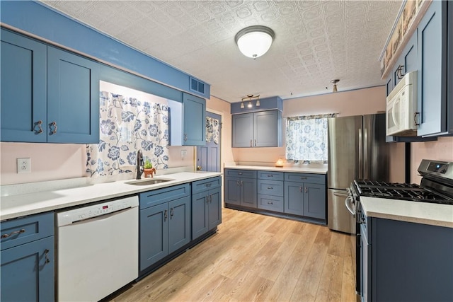 816 E 11th Ave, Munhall, PA 15120 - kitchen featuring white appliances, a sink, an ornate ceiling, light wood-style flooring, and light countertops