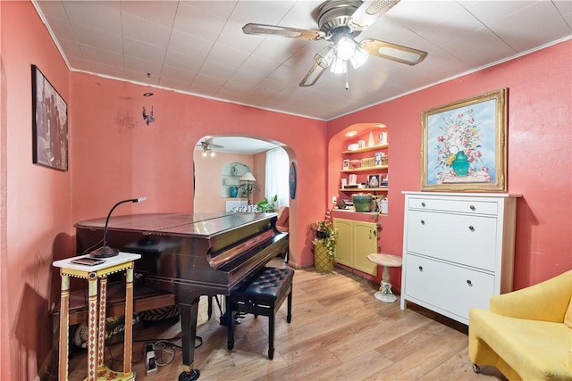 816 E 11th Ave, Munhall, PA 15120 - sitting room with ceiling fan, light wood finished floors, crown molding, and arched walkways