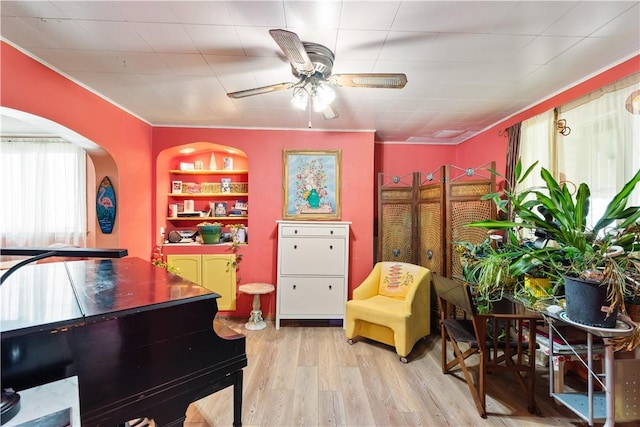 816 E 11th Ave, Munhall, PA 15120 - sitting room with wood finished floors, ceiling fan, and arched walkways