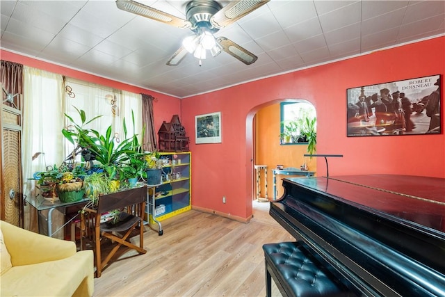 816 E 11th Ave, Munhall, PA 15120 - sitting room with arched walkways, wood finished floors, a ceiling fan, and baseboards