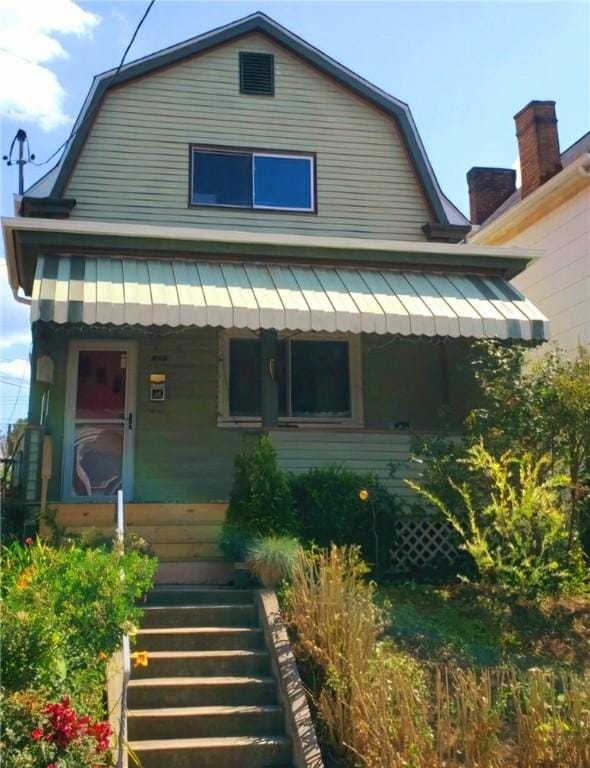 816 E 11th Ave, Munhall, PA 15120 - view of front of home featuring a gambrel roof, covered porch, and stairs