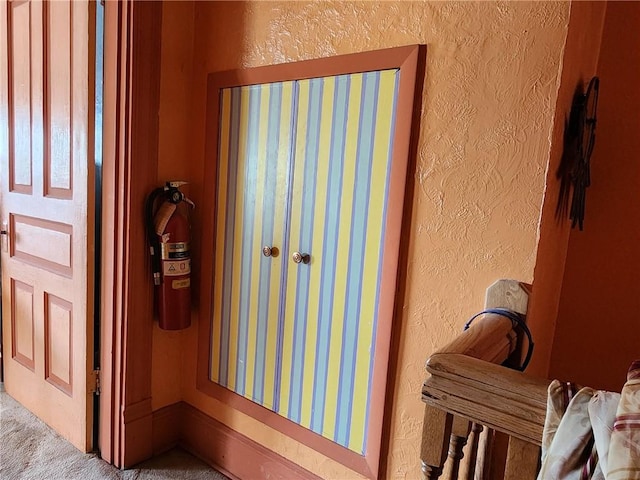 816 E 11th Ave, Munhall, PA 15120 - detailed view of a textured wall, a fire extinguisher, and carpet