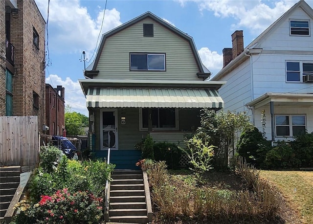 816 E 11th Ave, Munhall, PA 15120 - dutch colonial with a gambrel roof, stairs, and fence