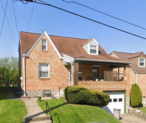 233 Clairmont Ave, West View, PA 15229 - view of front facade featuring a garage, a front yard, brick siding, and concrete driveway