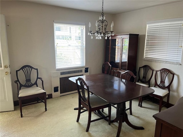 233 Clairmont Ave, West View, PA 15229 - dining room featuring radiator heating unit, light colored carpet, and a chandelier