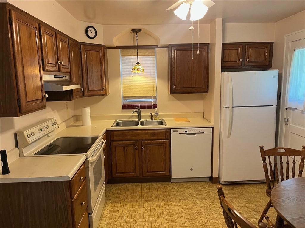 233 Clairmont Ave, West View, PA 15229 - kitchen featuring white appliances, a sink, under cabinet range hood, light countertops, and pendant lighting