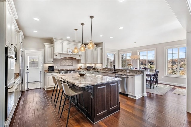 347 Buckingham Dr, Peters Twp, PA 15367 - kitchen with appliances with stainless steel finishes, a sink, a peninsula, a center island, and dark wood-style flooring