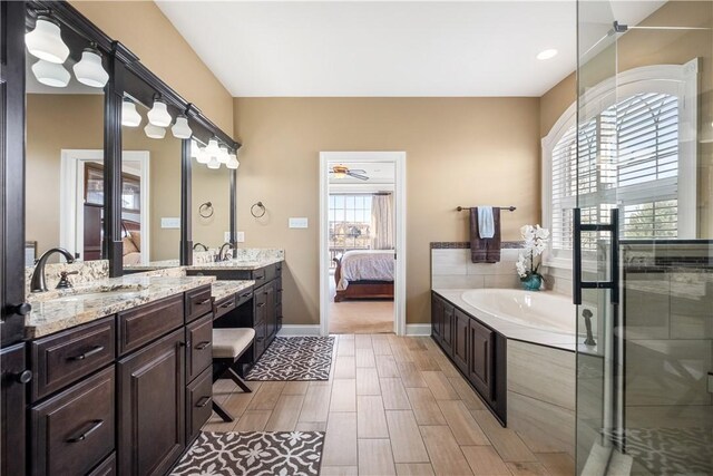 347 Buckingham Dr, Peters Twp, PA 15367 - bathroom featuring ensuite bathroom, vanity, a bath, wood finished floors, and baseboards