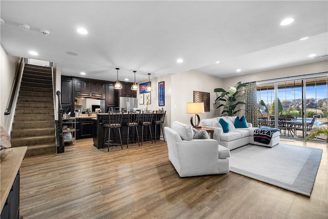 347 Buckingham Dr, Peters Twp, PA 15367 - living room featuring recessed lighting, stairway, light wood-style floors, and a dry bar