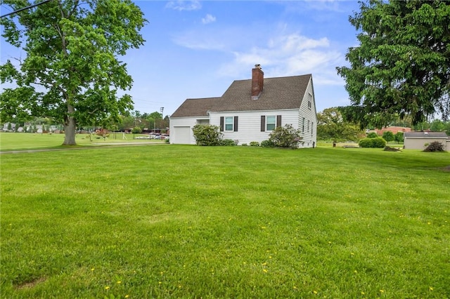 3601 Sharon Rd, West Middlesex Boro, PA 16159 - back of property featuring a chimney, a garage, and a lawn