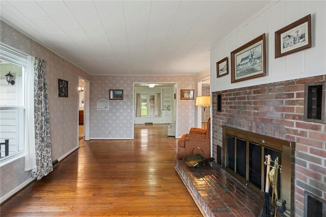 3601 Sharon Rd, West Middlesex Boro, PA 16159 - living area featuring a fireplace, hardwood / wood-style floors, wallpapered walls, baseboards, and ornamental molding