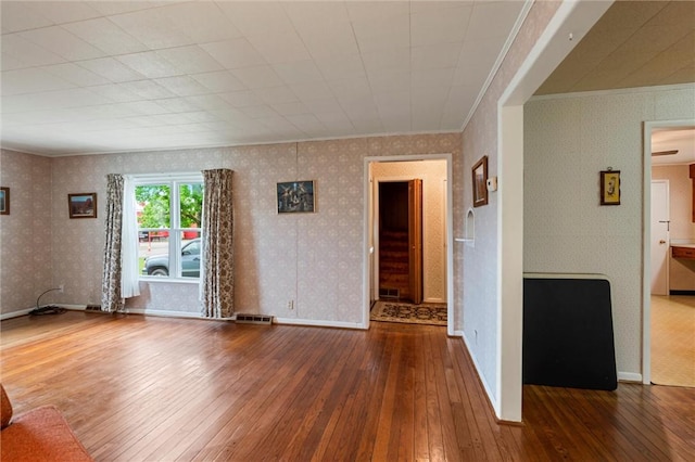 3601 Sharon Rd, West Middlesex Boro, PA 16159 - unfurnished room featuring hardwood / wood-style flooring, ornamental molding, wallpapered walls, and baseboards