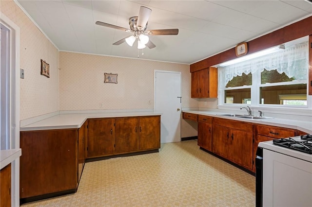 3601 Sharon Rd, West Middlesex Boro, PA 16159 - kitchen with a sink, a ceiling fan, white range with gas cooktop, and brown cabinets
