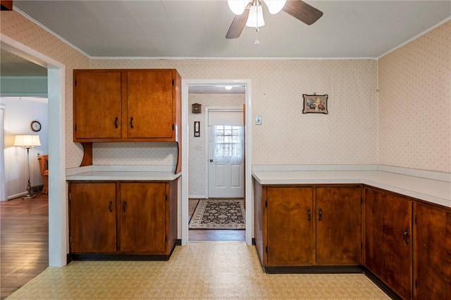 3601 Sharon Rd, West Middlesex Boro, PA 16159 - kitchen with ornamental molding, ceiling fan, light countertops, brown cabinets, and light floors