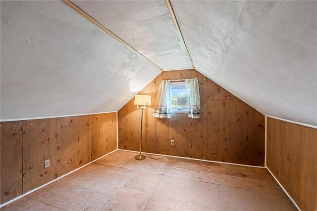 3601 Sharon Rd, West Middlesex Boro, PA 16159 - additional living space featuring lofted ceiling, wood walls, a textured ceiling, and baseboards
