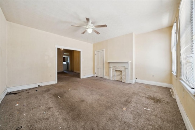 unfurnished living room with plenty of natural light, ceiling fan, and carpet