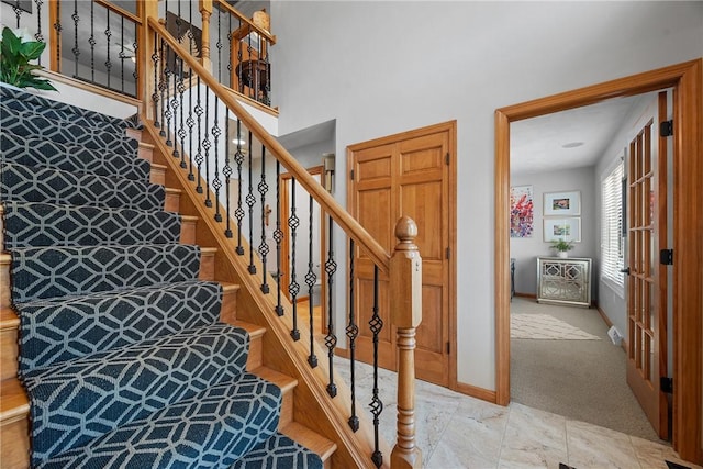 stairs with baseboards and carpet