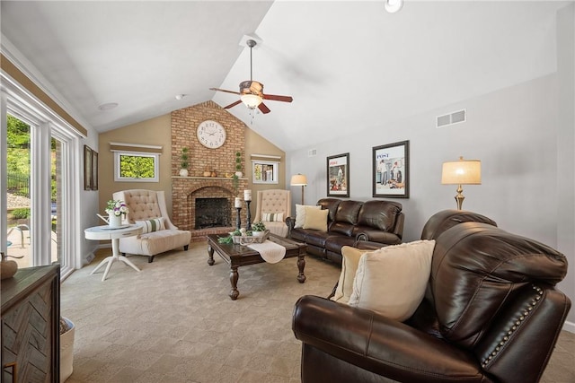 living area with ceiling fan, vaulted ceiling, light colored carpet, and a brick fireplace