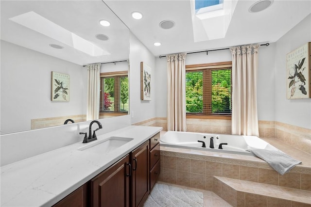 full bathroom featuring a skylight, a bath, plenty of natural light, and recessed lighting